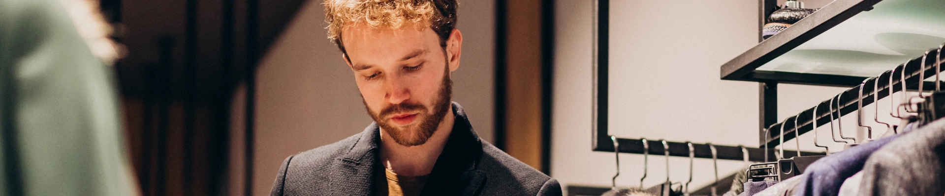 Young Handsome Man Choosing Shirt Shop