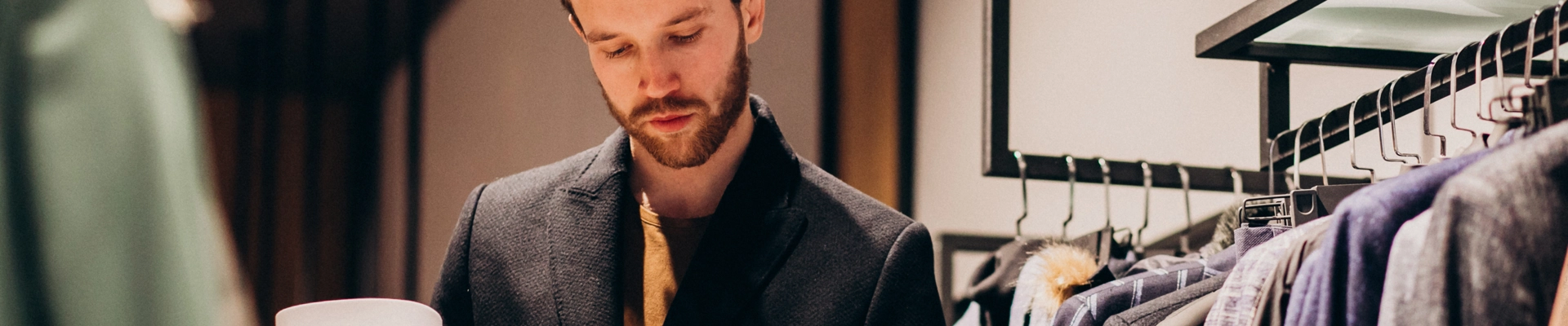 Young Handsome Man Choosing Shirt Shop