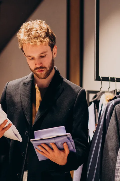 Young Handsome Man Choosing Shirt Shop